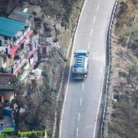 vista aerea dall'alto dei veicoli stradali che guidano su strade di montagna a nainital, india, uttarakhand, vista dal lato superiore della montagna per il movimento di veicoli stradali foto