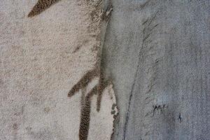 trama di un muro di cemento con crepe e graffi che possono essere utilizzati come sfondo foto