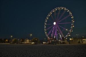 una giostra al parco divertimenti sulla spiaggia di notte foto