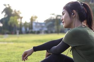 faccia laterale di una giovane donna seduta in un parco. foto