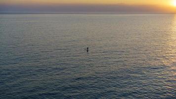 paesaggio muggito con silhouette di un uomo su una tavola di linfa foto