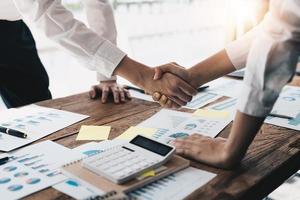 due uomini d'affari fiduciosi che si stringono la mano durante una riunione in ufficio, successo, trattativa, saluto e concetto di partner. foto