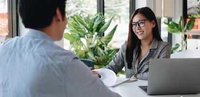 datore di lavoro o reclutatore che legge un curriculum durante un colloquio sul suo profilo di candidato, datore di lavoro che conduce un colloquio di lavoro, impiego delle risorse del manager e concetto di reclutamento. foto