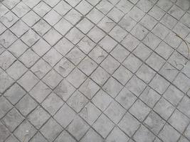 timbro cemento nero grigio colore indurente modelli di stampa sulla superficie del cemento o della malta forma del blocco motivo quadrato materiale struttura ruvida sfondo foto