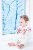 piccolo bambino sveglio in maglione lavorato a maglia con l'ornamento del fiocco di neve