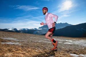 corridore di montagna in azione in salita su fondo scivoloso foto