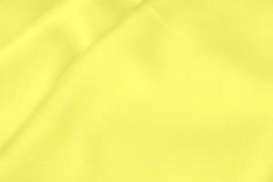 tessuto di raso giallo texture morbida sfocatura dello sfondo foto