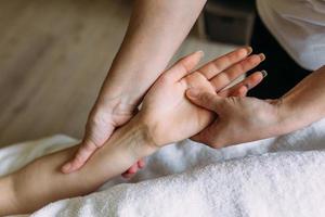 il massaggiatore fa un massaggio ai piedi femminili alle terme. il concetto di procedure cosmetiche. foto