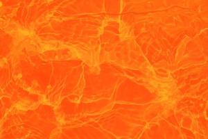 sfocatura sfocata calma acquerello arancione in piscina increspata acqua dettaglio sfondo. spruzzi d'acqua, sfondo di spruzzi d'acqua. foto