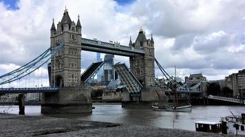 una vista del Tower Bridge di Londra con l'apertura del ponte levatoio foto
