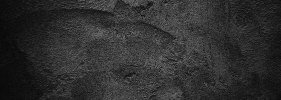 parete nera spaventosa o grigio scuro ruvida pietra granulosa texture di sfondo. cemento nero per lo sfondo. foto