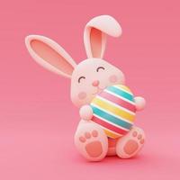 coniglietto di pasqua con uova di pasqua colorate isolate su sfondo rosa, concetto di vacanza di buona pasqua. stile minimal, rendering 3d. foto