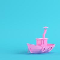 barca da pesca rosa su sfondo blu brillante in colori pastello foto