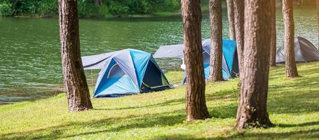 campeggio sotto la pineta, tenda blu vicino al lago di pang oung, mae hong son, thailandia. concetto di viaggio, viaggio e vacanza foto