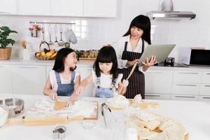 la sorellina che cerca la madre e la piccola figlia fanno una cottura foto