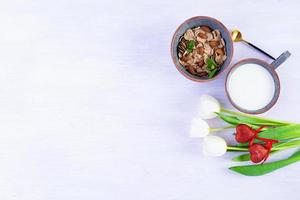 fiocchi di farro con latte a colazione. colazione leggera a san valentino con tulipani e cuore foto