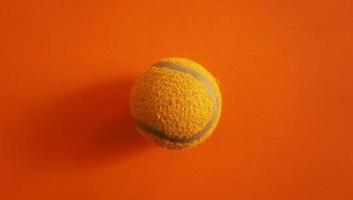pallina da tennis su sfondo colorato foto