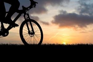 sagome di mountain bike e ciclisti la sera felici. concetto di viaggio e fitness. silhouette di ciclisti in tournée la sera concetto di cicloturismo foto