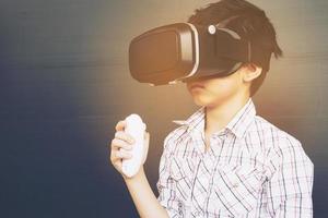 Bambino di 7 anni che gioca a un gioco di realtà virtuale vr foto