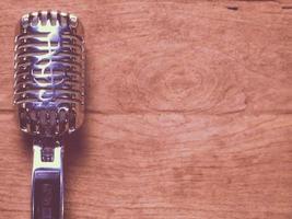microfono classico in stile vintage posizionato su un vecchio legno. foto