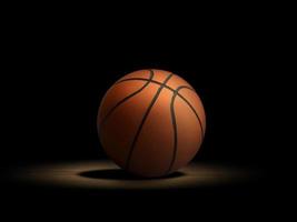 palla da basket sul parquet con sfondo nero foto