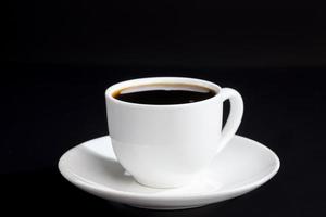 tazza di vetro bianca con delizioso caffè aromatico nero foto