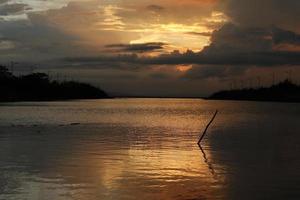 cielo drammatico colorato con nuvole al tramonto. tramonto nel lago foto