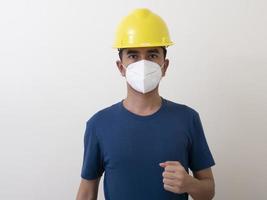 i lavoratori dell'industria asiatica indossano elmetti gialli, indossano maschere protettive per la loro salute