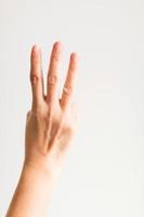 una mano che mostra tre dita per contare tre. foto