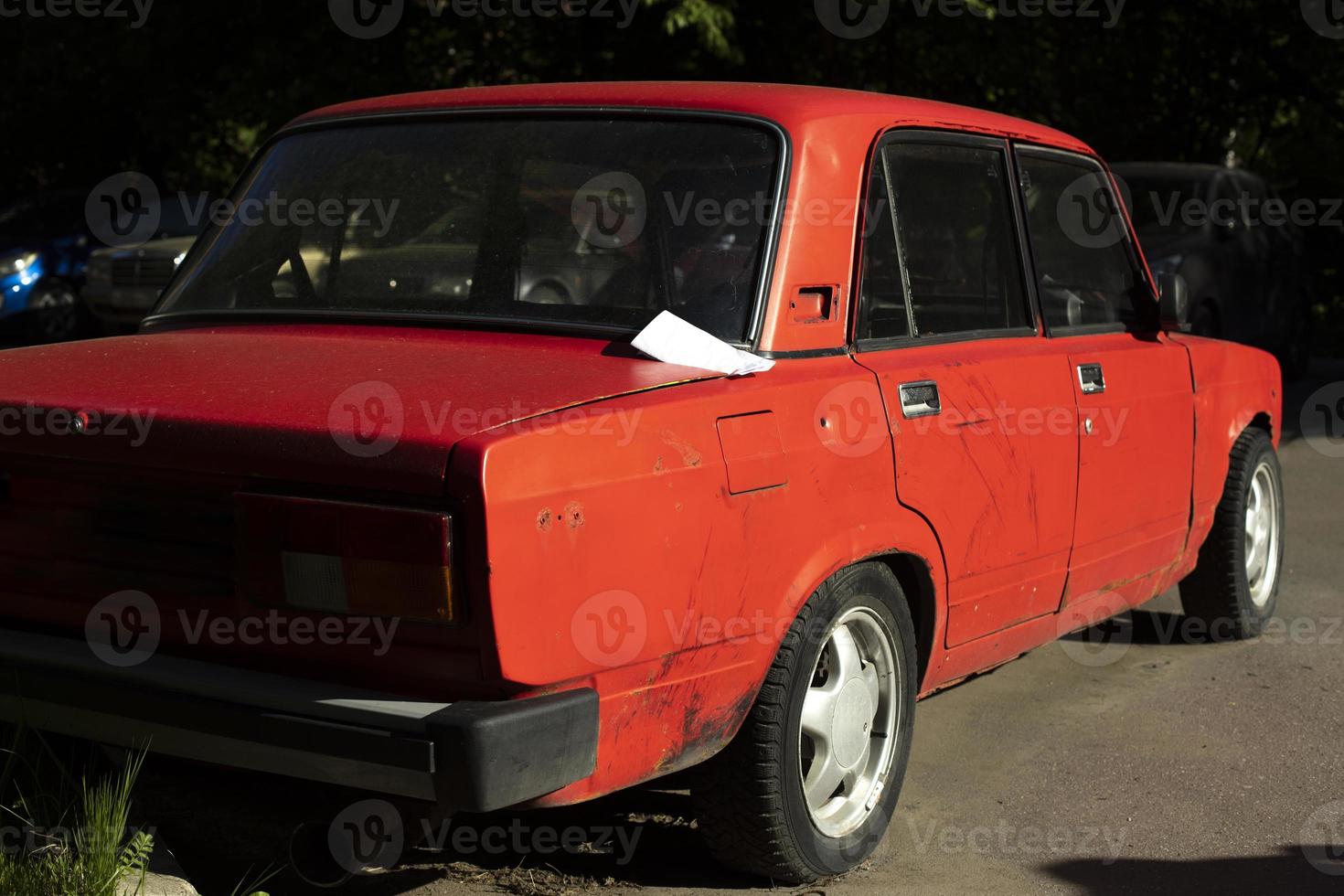 carro vermelho no verão. carro no estacionamento. carro russo na rua. foto