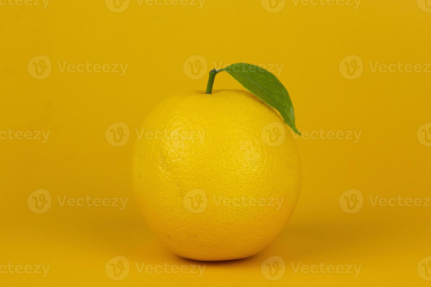 um limão isolado em fundo amarelo. limão amarelo para design de conceito de frutas saudáveis foto