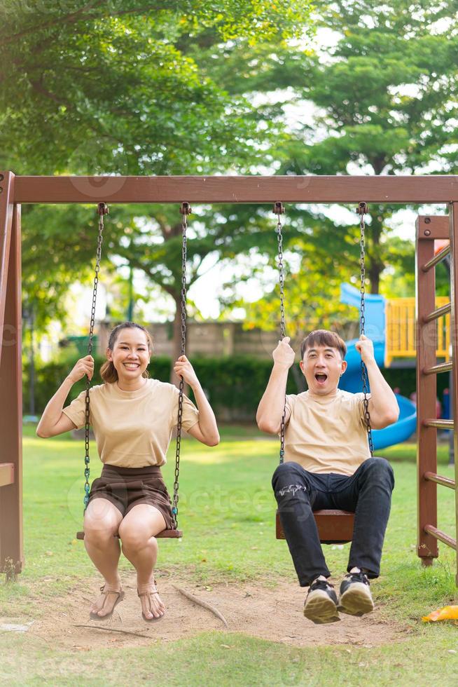 casal asiático adora brincar no balanço foto