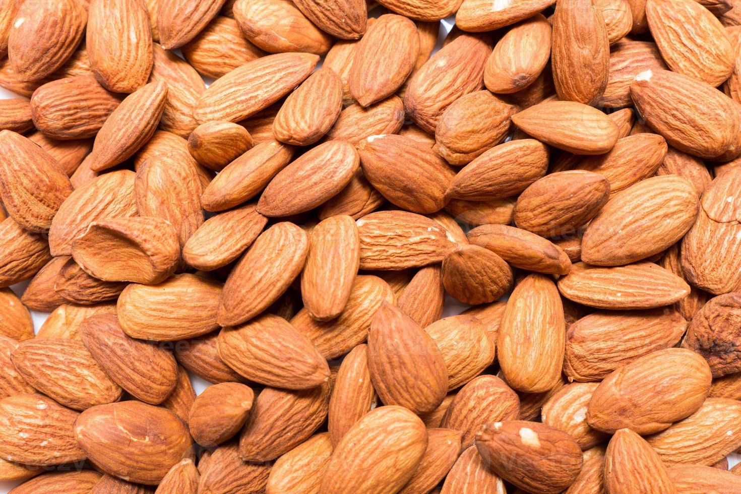 fundo de nozes de amêndoa inteira. lanche saudável vegetariano. comida orgânica. dieta vegetal. foto de alta qualidade