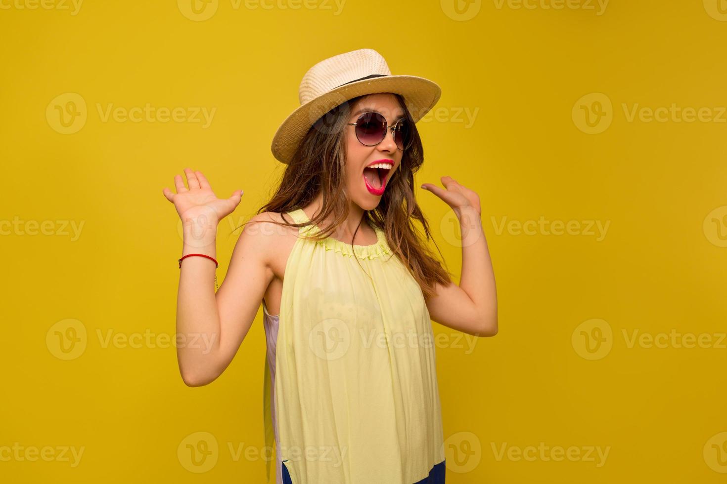 feliz senhora surpreendida vestido de verão brincando no estúdio e pulando. adorável garota se diverte em fundo colorido e levantou as mãos. foto