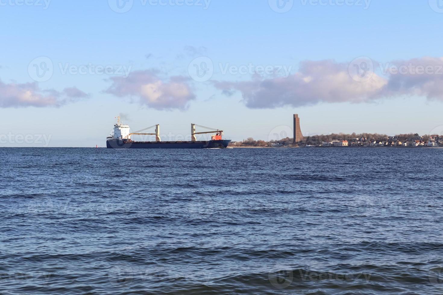 grande navio de carga na água do mar Báltico. vista da praia em laboe na alemanha foto