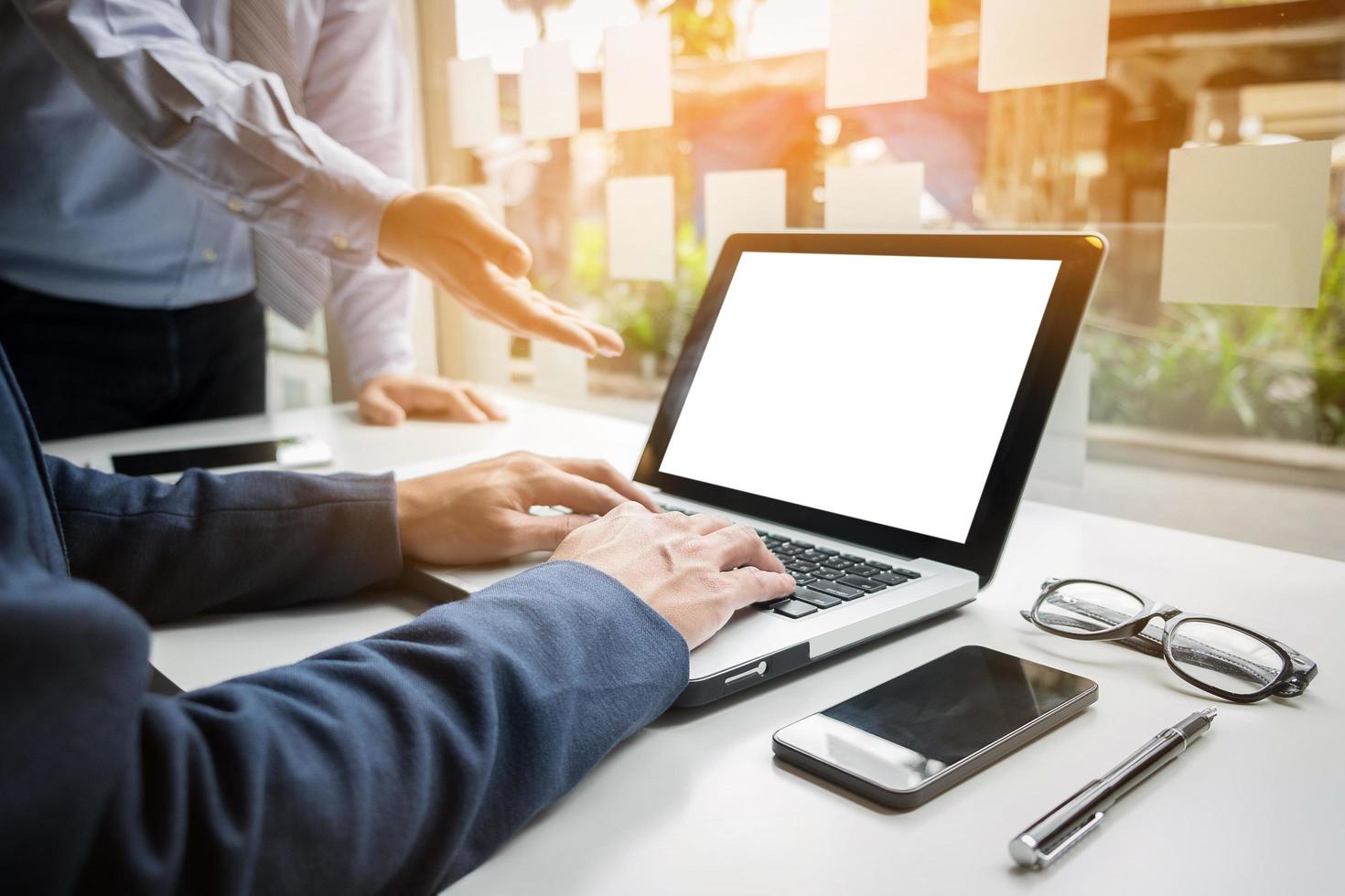 mãos de empresário trabalhando com computador tablet digital e telefone inteligente com gráfico de negócios na mesa como conceito. foto