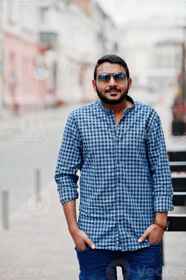 homem modelo de barba indiana elegante em roupas casuais posou ao ar livre na rua da índia. foto