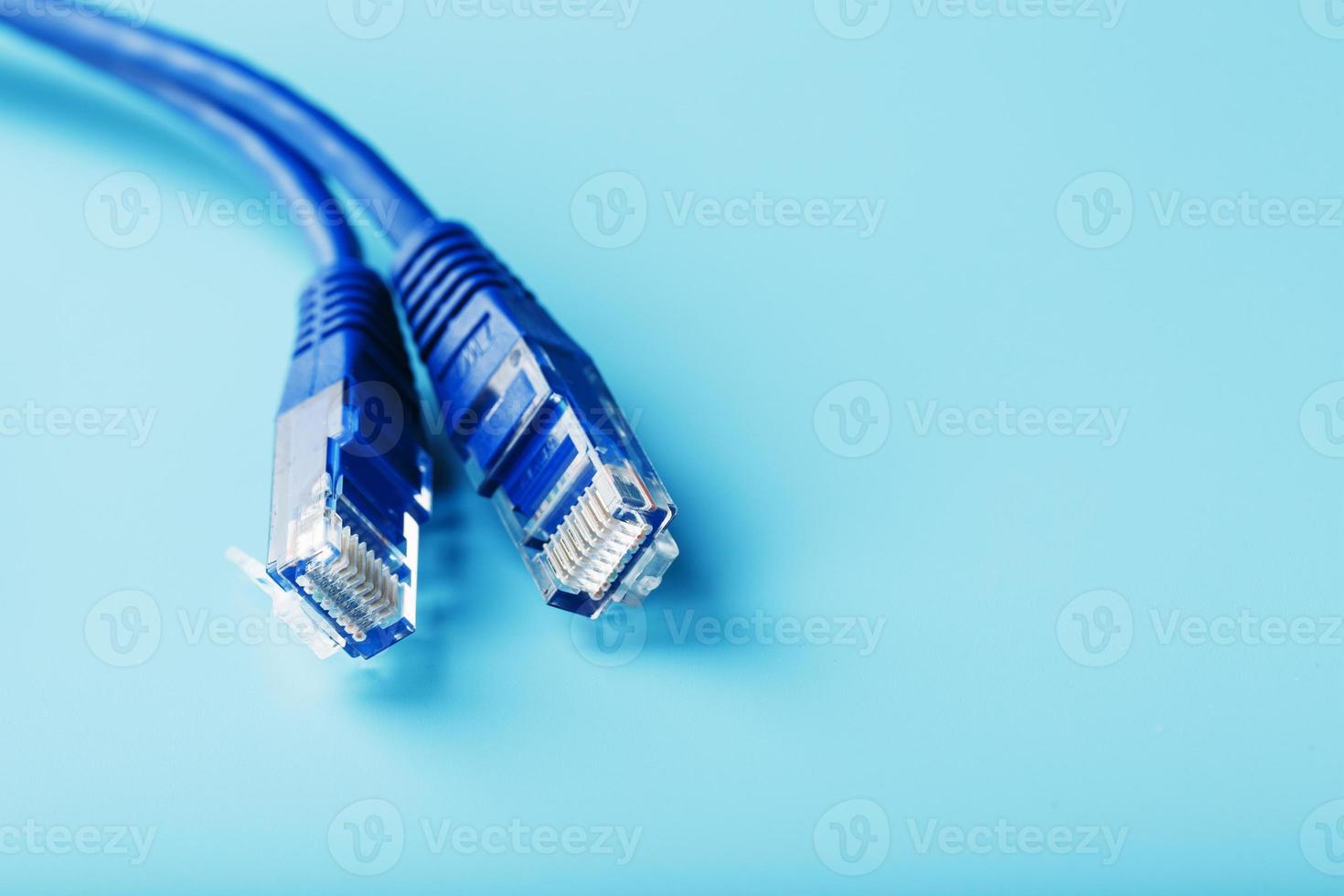 close-up do cabo de remendo do conector do cabo ethernet em um fundo azul com espaço livre foto