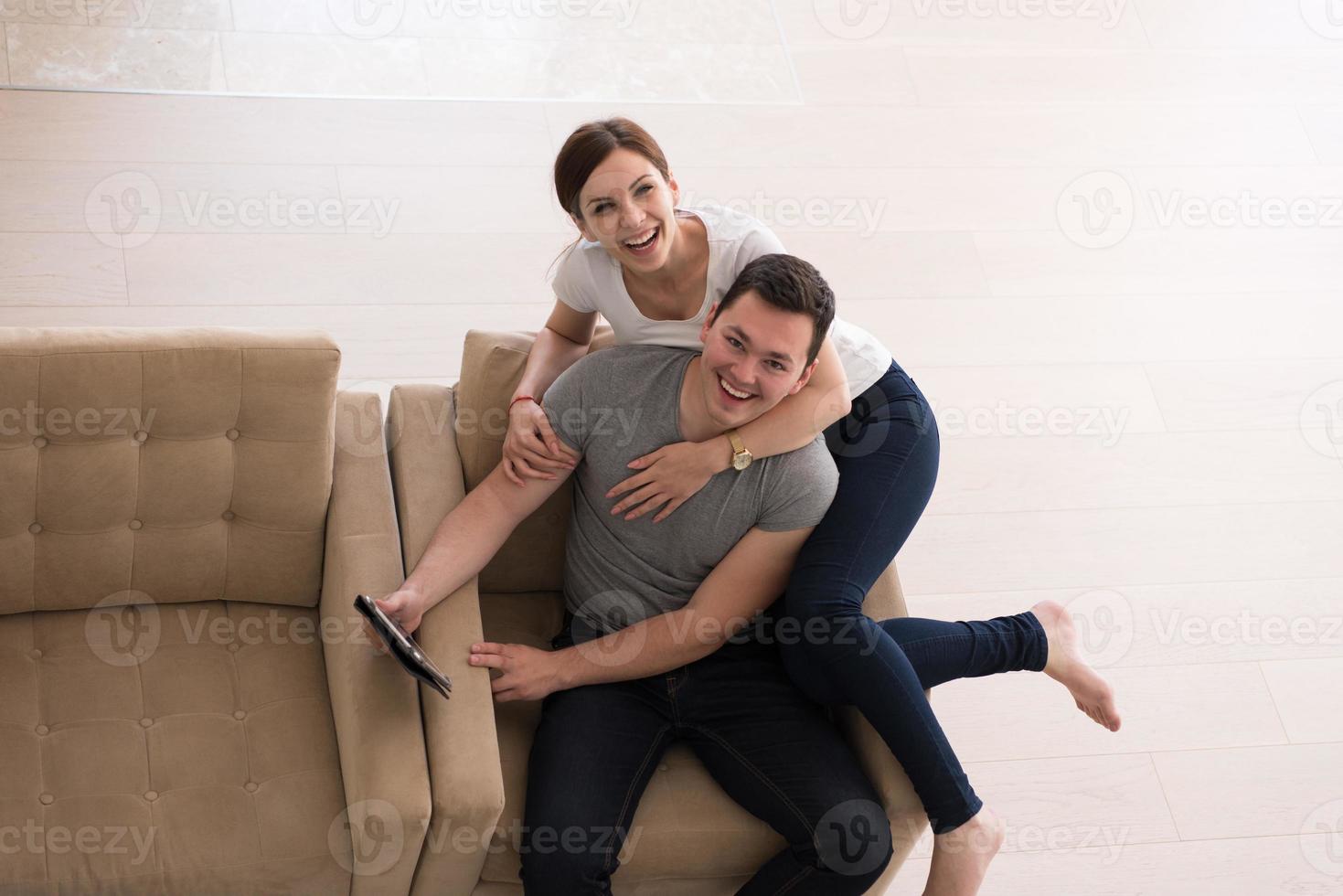 casal relaxando em casa com computadores tablet foto