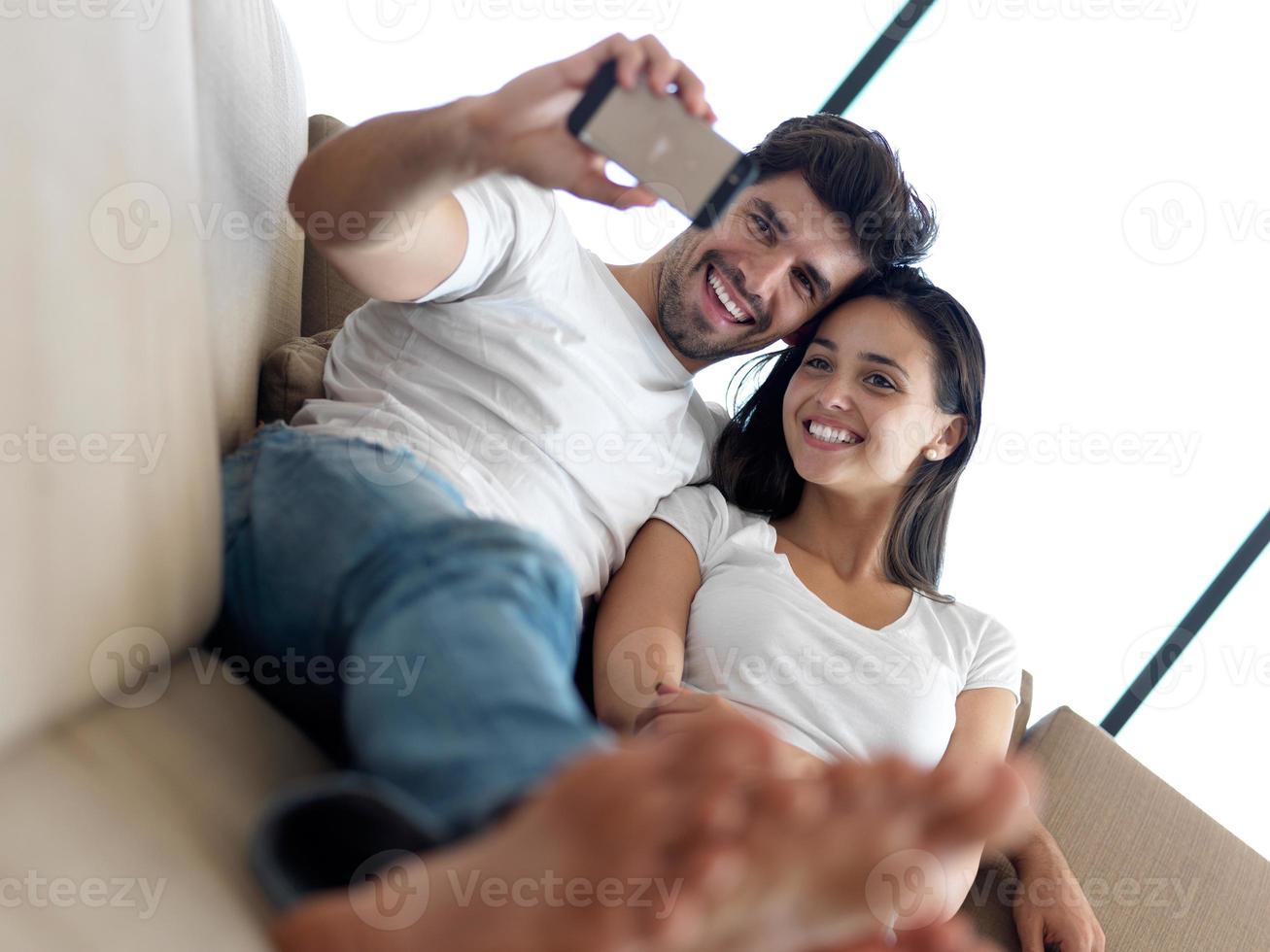 jovem casal fazendo selfie juntos em casa foto