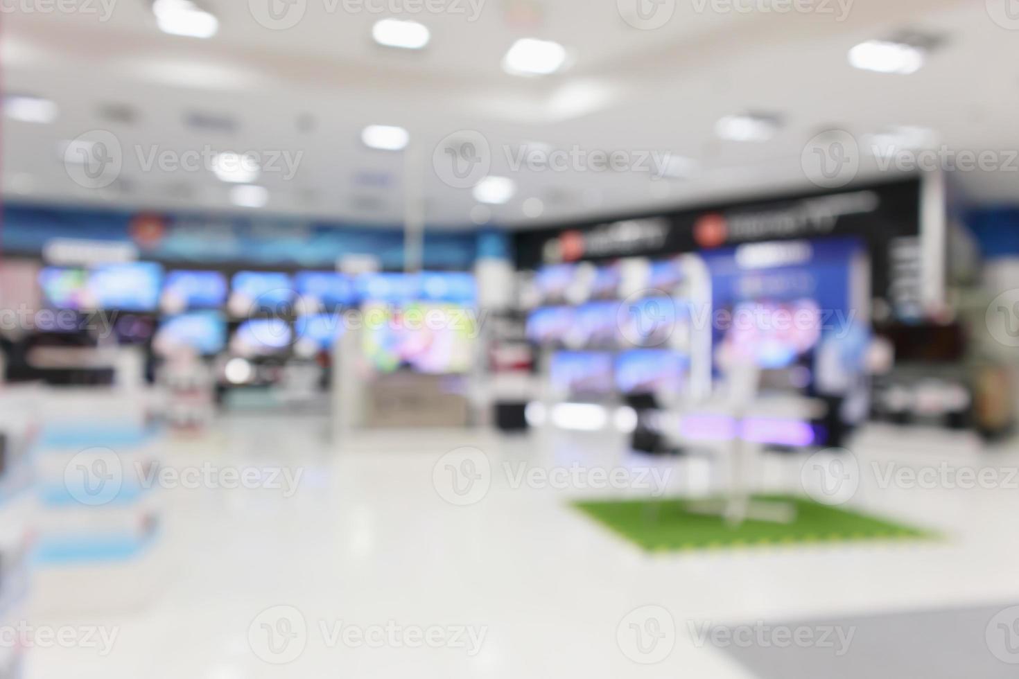 loja de departamentos eletrônicos mostra tv de televisão e eletrodomésticos com fundo desfocado luz bokeh foto