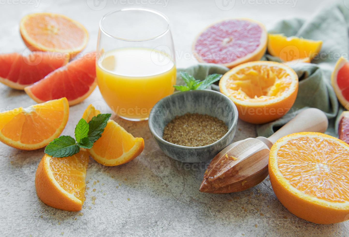 copo de suco e frutas cítricas foto