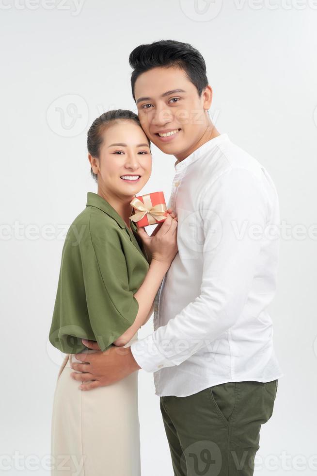 casal jovem feliz com presente de dia dos namorados isolado em um fundo branco. foto