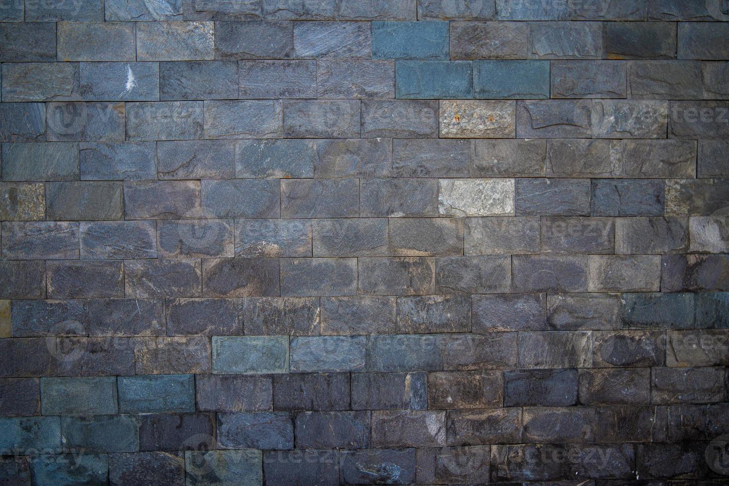 parede de pedra cinza com pedras de tamanhos diferentes, tapume moderno close-up. textura de uma parede de pedra. antigo fundo de textura de parede de pedra do castelo. parede de pedra como pano de fundo ou textura. elemento de projeto. foto