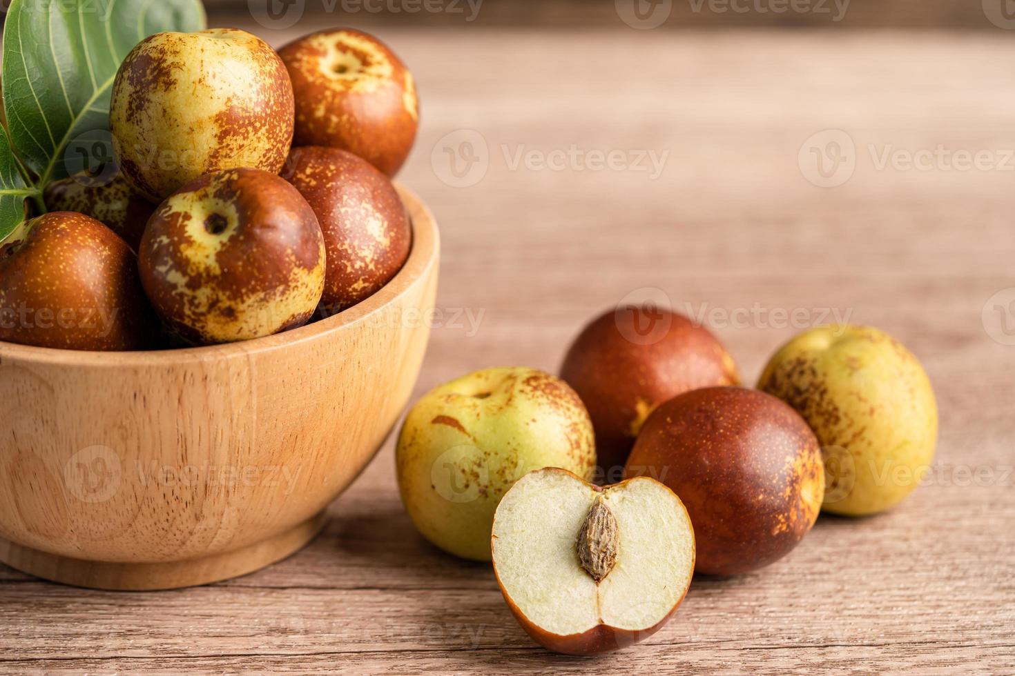 fruta jujuba ou datas chinesas em uma tigela de madeira, comida saudável. foto