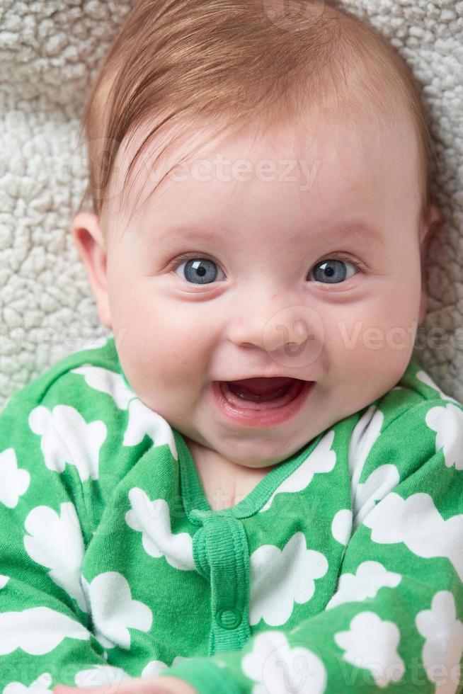 bebezinho brincando com as mãos e sorrindo foto