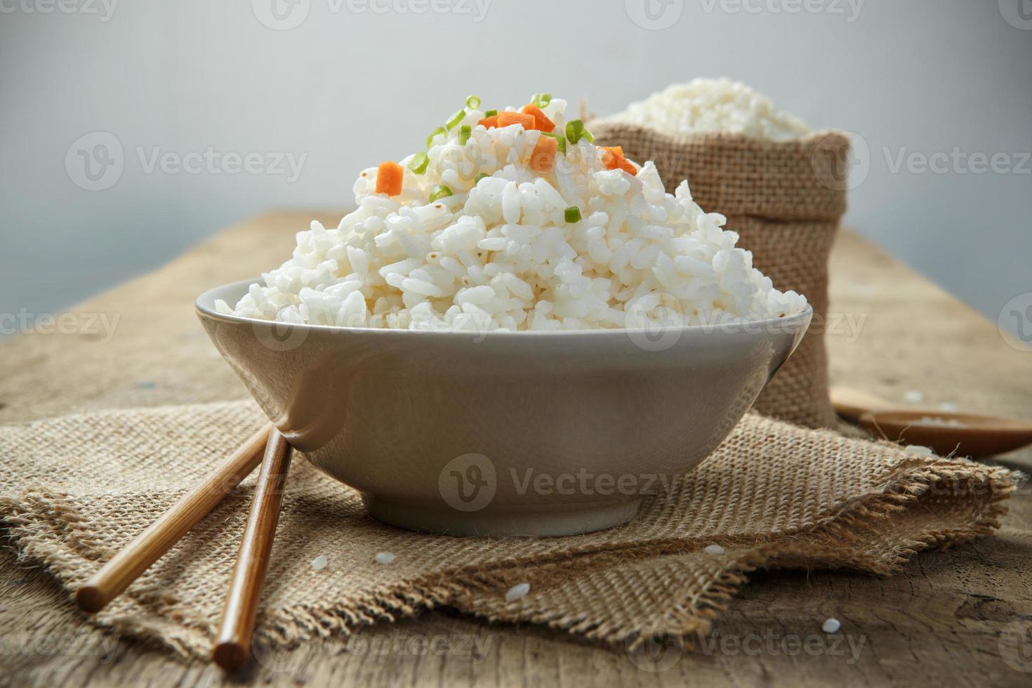 close-up de arroz cozido no vapor com pauzinhos na serapilheira foto