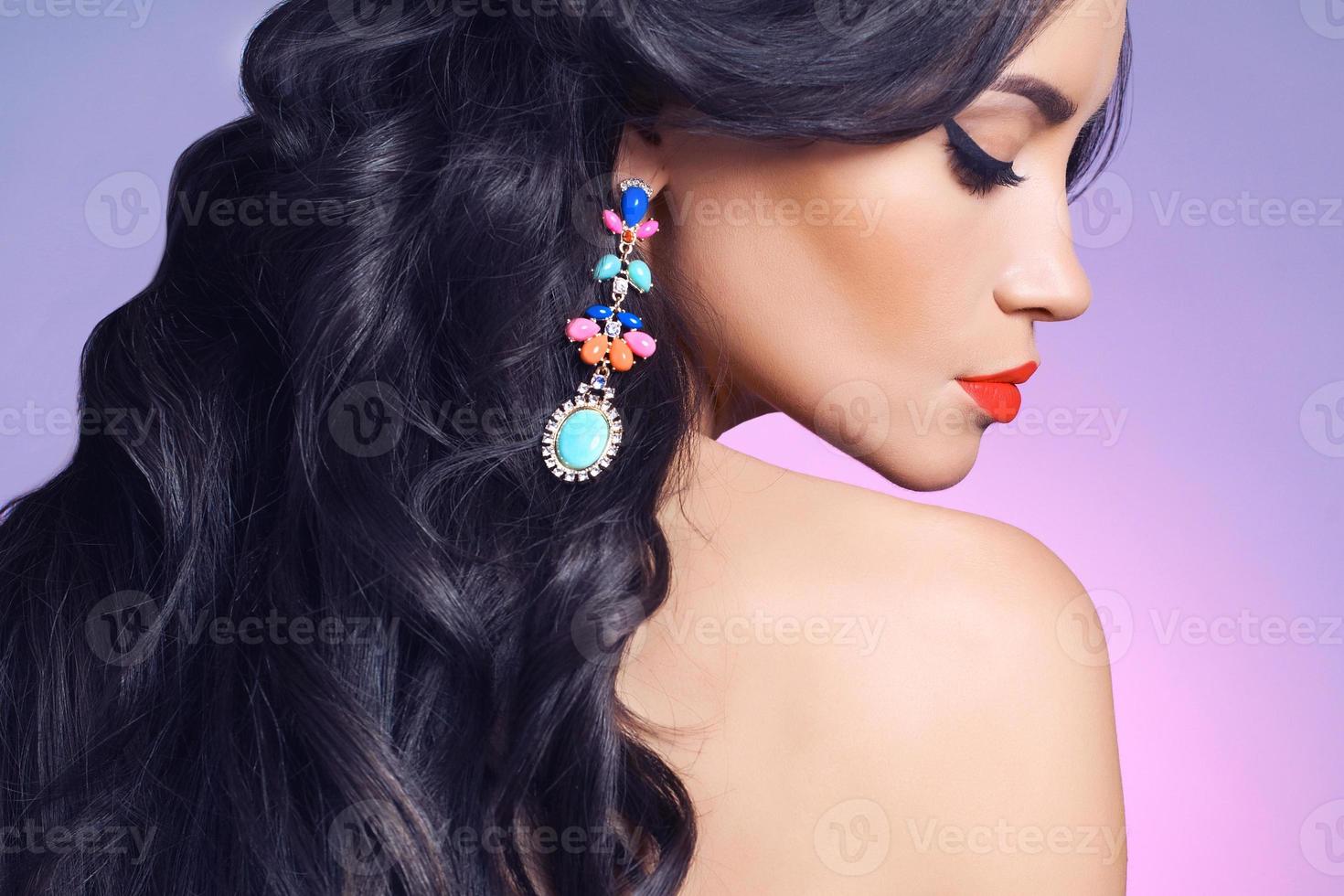 perfil lateral de mulher usando um brinco colorido foto