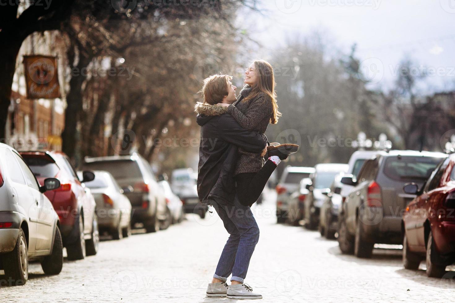 cara e a garota se divertindo em uma rua da cidade foto