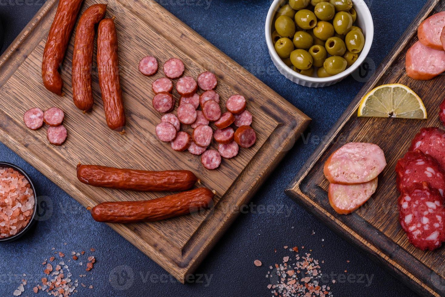 deliciosas salsichas defumadas frescas cortadas com fatias em uma tábua de madeira foto